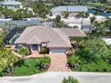 A captivating aerial view reveals this tropical residence, featuring lush landscaping and a brick driveway at 2779 N Beach Rd # A, Englewood, FL 34223