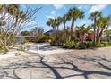 Charming home featuring mature landscaping, a white picket fence, and a shell drive for a quintessential coastal feel at 2779 N Beach Rd # A, Englewood, FL 34223