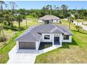Aerial view of a modern home featuring a gray roof and a spacious driveway at 3140 Lopinto St # 1, North Port, FL 34287