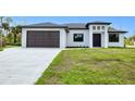 Beautiful home featuring a two-car garage and a contemporary front entrance at 3140 Lopinto St # 1, North Port, FL 34287