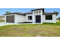 Modern home with a two-car garage and a striking front entrance at 3140 Lopinto St # 1, North Port, FL 34287