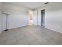 Cozy bedroom boasting neutral walls, tile flooring, and a closet for storage at 3420 Dawson Ln, Punta Gorda, FL 33982