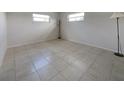Bright bedroom featuring tile flooring, neutral walls, and natural light from windows at 3420 Dawson Ln, Punta Gorda, FL 33982