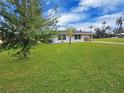 Well-maintained single-story home with lush green lawn and beautiful landscaping at 3420 Dawson Ln, Punta Gorda, FL 33982