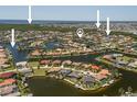 Expansive aerial view of waterfront homes, showcasing the property's location in a desirable coastal neighborhood with water access at 3705 Toulouse Ct, Punta Gorda, FL 33950