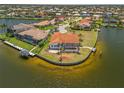 Aerial view of the waterfront home with access to the Gulf of Mexico, featuring a screened lanai and private dock at 3705 Toulouse Ct, Punta Gorda, FL 33950