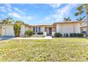 Charming single-story home with attached garage, manicured lawn, and inviting front entrance at 3824 Aves Island Ct, Punta Gorda, FL 33950