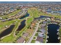 Stunning aerial view of a golf course community with lakes and beautiful homes at 4001 La Costa Island Ct, Punta Gorda, FL 33950