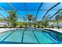 Enjoy this screened pool with a beautiful waterfall feature surrounded by tropical landscaping at 420 Wabash Ter, Port Charlotte, FL 33954