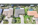 An aerial view of the house showcasing its roof, landscaping, circular driveway, and proximity to the water at 505 Via Cintia, Punta Gorda, FL 33950