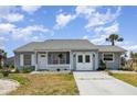 Charming single-story home featuring a well-manicured lawn and a cozy front porch with white picket fence at 5121 Chaves Cir, Port Charlotte, FL 33948