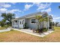 Inviting single-story home with a well-maintained lawn and decorative landscaping at 5121 Chaves Cir, Port Charlotte, FL 33948