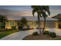 Charming home exterior at dusk with well-maintained landscaping and welcoming curb appeal at 859 Napoli Ln, Punta Gorda, FL 33950