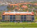 Exterior of condo building showing multiple floors with balconies and an orange tile roof at 93 Vivante Blvd # 9344, Punta Gorda, FL 33950