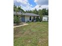 Lovely single-story home featuring a lush front yard and welcoming curb appeal at 1457 Sheehan Blvd, Port Charlotte, FL 33952