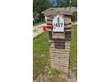 Close-up of a brick mailbox displaying the house number on a well-manicured lawn at 1457 Sheehan Blvd, Port Charlotte, FL 33952
