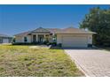 Well-maintained single-story home with inviting curb appeal, featuring a landscaped yard and attached two-car garage at 1606 Navigator Rd, Punta Gorda, FL 33983