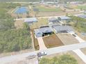 An aerial view showing the home's position in the community near baseball fields and a pond at 2229 Wakefield St, Port Charlotte, FL 33948