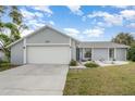 Inviting single Gathering home featuring a lush front lawn and attached two-car garage at 242 Seminole Nw Blvd, Port Charlotte, FL 33952