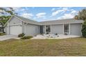 Charming single-story home showcasing a well-maintained yard and inviting curb appeal at 242 Seminole Nw Blvd, Port Charlotte, FL 33952