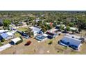 An aerial view of a home with screened-in pool, solar panels, a large yard and neighborhood at 3249 Cedarbrook Dr, Punta Gorda, FL 33982