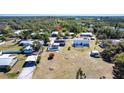 Aerial view of a home with a screened-in pool and spacious backyard near lush trees and waterways at 3249 Cedarbrook Dr, Punta Gorda, FL 33982