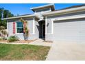 Close-up of a charming single-story home with a well-kept lawn, two car garage, and inviting curb appeal at 3476 Brewster Rd, North Port, FL 34288