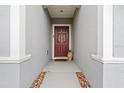 Inviting front entrance featuring a decorative red door with stylish wreath and stone walkway at 3476 Brewster Rd, North Port, FL 34288