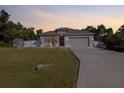 Charming single-story home boasts a well-manicured lawn, two car garage, and inviting curb appeal at 3476 Brewster Rd, North Port, FL 34288