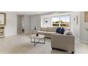 Comfortable living room with a large window and neutral-toned furniture at 3480 Pinetree St, Port Charlotte, FL 33952