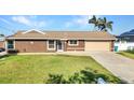 Inviting one-story home with lush green lawn, well-maintained landscaping, and attached garage at 4178 Rose Arbor Cir, Port Charlotte, FL 33948
