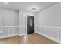 Bright entryway with modern wood flooring, decorative door, and neutral wall color at 4290 Yucatan Cir, Port Charlotte, FL 33948