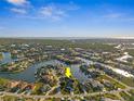 An aerial view showing a waterfront community with lush landscaping at 529 La Caruna Ct, Punta Gorda, FL 33950