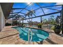 Screened in kidney-shaped pool overlooking a waterway and lush landscaping at 529 La Caruna Ct, Punta Gorda, FL 33950