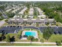 Aerial view of condo community with a swimming pool, parking and mature trees at 5416 Swift Rd # 27, Sarasota, FL 34231