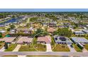 Aerial view of a neighborhood showcasing a single-Gathering home with lush landscaping in a residential area at 452 Greenwich Nw Ave, Port Charlotte, FL 33952