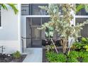 Ground floor condo entrance with private, screened in patio and lush landscaping around front walkway at 14204 Heritage Landing Blvd # 712, Punta Gorda, FL 33955