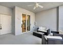 Comfortable condo screened patio featuring outdoor seating, fan and sliding glass door to the interior at 14204 Heritage Landing Blvd # 712, Punta Gorda, FL 33955