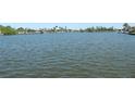 Scenic water view showcasing the tranquil waterfront property and lush landscaping at 15490 Seafoam Cir, Port Charlotte, FL 33981