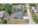 Aerial view of a home with a screened pool, lush greenery, and a private backyard at 1556 Eagle St, Port Charlotte, FL 33952