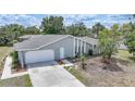 Stylish single-story home with a wide driveway and well-manicured front yard at 1556 Eagle St, Port Charlotte, FL 33952