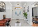 Bright foyer with high ceilings, decorative glass front doors, and tile flooring at 16450 Bauers Ave, Port Charlotte, FL 33954