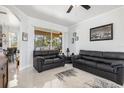 Comfortable living room with tile flooring, ceiling fan, and access to the outdoor patio at 16450 Bauers Ave, Port Charlotte, FL 33954