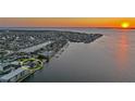 Breathtaking aerial view of the waterfront property, nestled on a tranquil canal with sunset backdrop at 1820 Jamaica Way, Punta Gorda, FL 33950