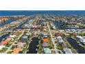 Aerial view of a waterfront community with direct gulf access and a canal behind the home at 211 Lido Dr, Punta Gorda, FL 33950