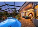 Stunning outdoor oasis featuring a luxurious pool, hot tub, screened lanai, and comfortable seating area at 211 Lido Dr, Punta Gorda, FL 33950