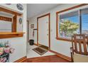 Entryway with wood trim, tile flooring, coat rack, and bright natural light at 22375 Edgewater Dr # 255, Punta Gorda, FL 33980