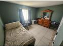 Cozy bedroom with ample natural light and tiled floors at 2306 Lee Ter, Port Charlotte, FL 33952