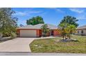 Charming single-story home with a two car garage and tropical landscaping at 23331 Billings Ave, Port Charlotte, FL 33954