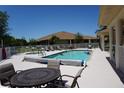Backyard swimming pool and patio area with outdoor furniture, perfect for relaxation at 24141 Green Heron Dr # 23, Punta Gorda, FL 33980